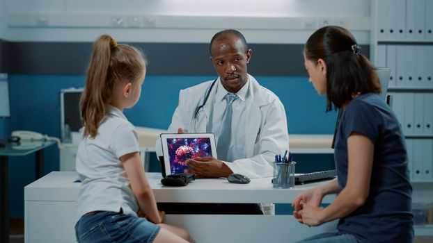 Health specialist showing virus illustration on digital tablet