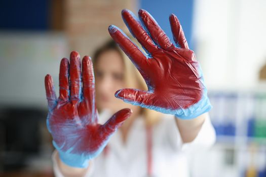 Bloodied hand in doctor medical gloves in clinic