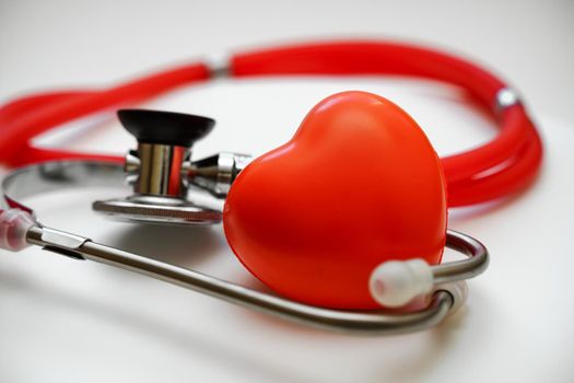 Stethoscope and red heart on white background, heart health, health insurance concept.