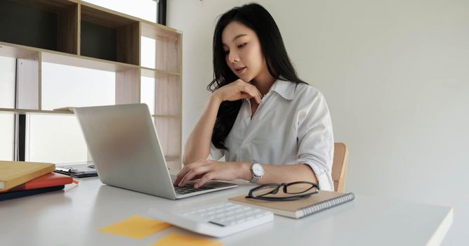 Asian businesswoman working with portable laptop computer