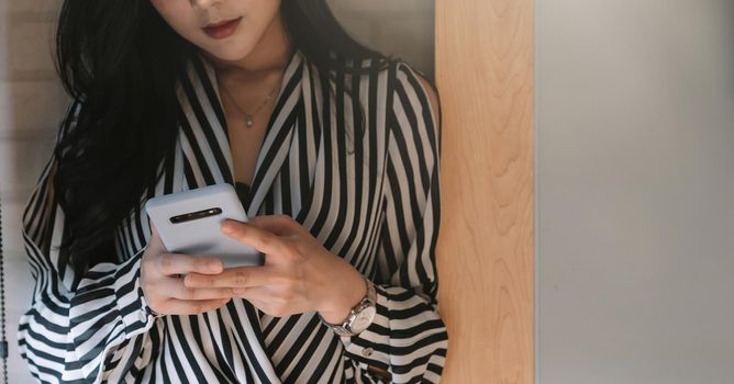 Business asian woman using smartphone at office