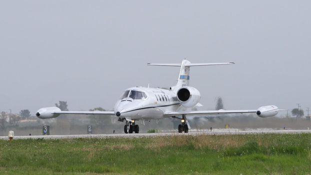 Andravida Greece APRIL, 1, 2022 Modern executive business jet of United Stated air force taxiing on the airport runway. Gates Learjet 35 C-21A of USAF used for passenger and cargo transportation