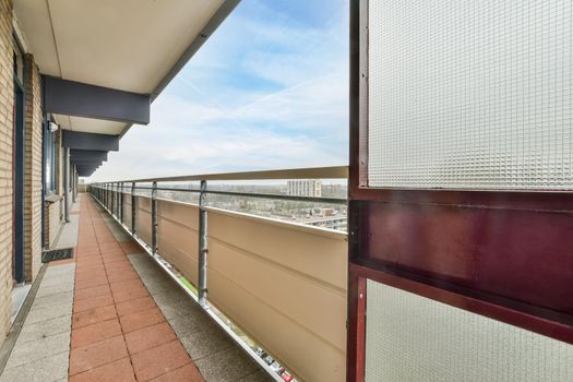 A long balcony with a metal fence