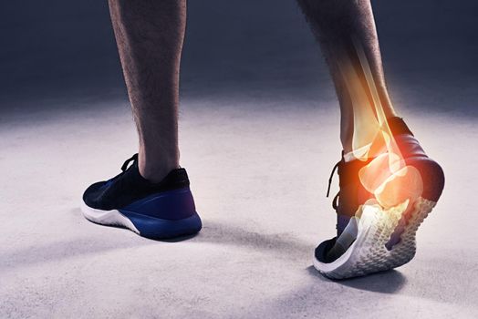 Putting an end to his run. Cropped shot of a young man in the studio with cgi highlighting his ankle injury.