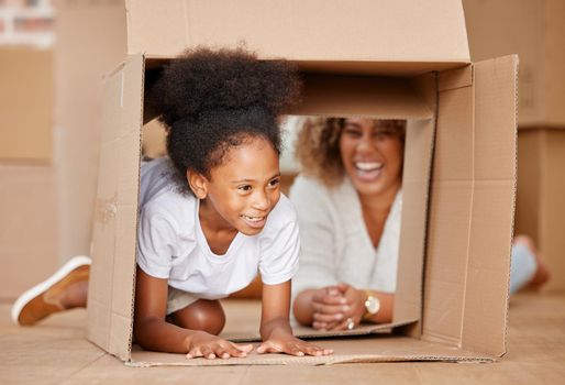 shot of a mother playing with her daughter in a box at home.