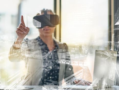Reaching out to a wider business network with virtual reality. Shot of a young businesswoman wearing a virtual reality headset at work.