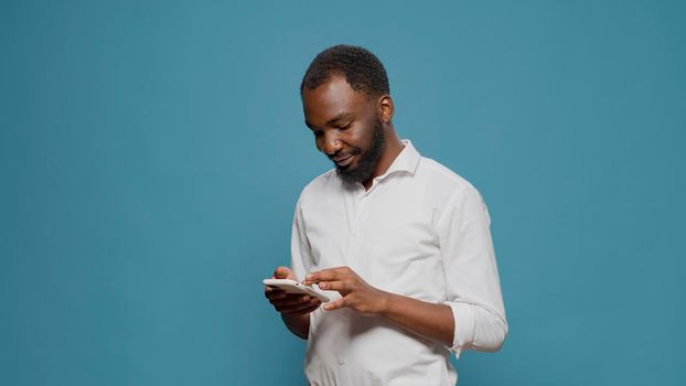 African american person working on modern smartphone
