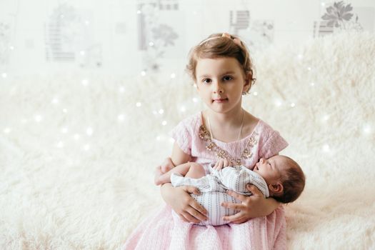 happy little girl with her newborn baby brother.