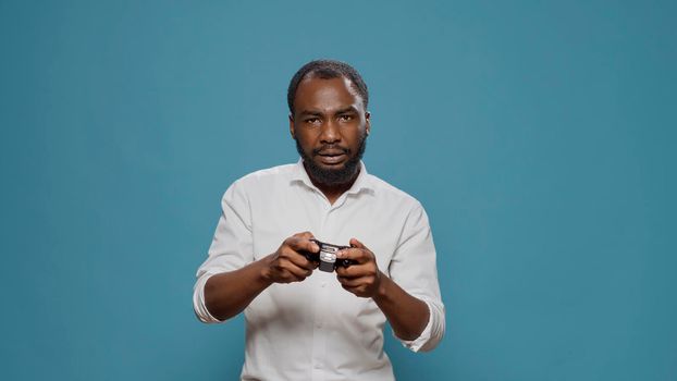 Modern person using controller to play video games in studio