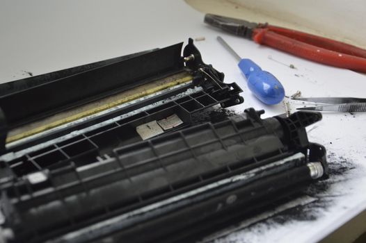 Charging the laser printer cartridge with toner powder