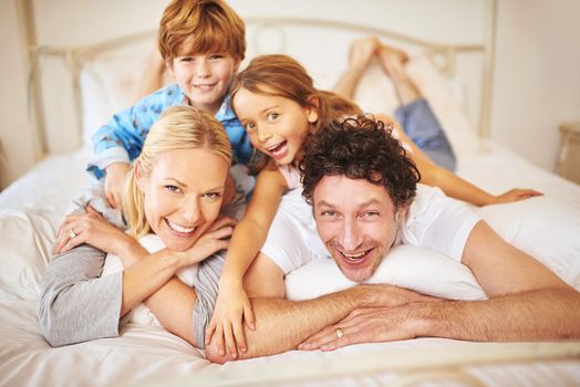Family are the light and love of life. Portrait of a happy family having some fun together in the morning at home.