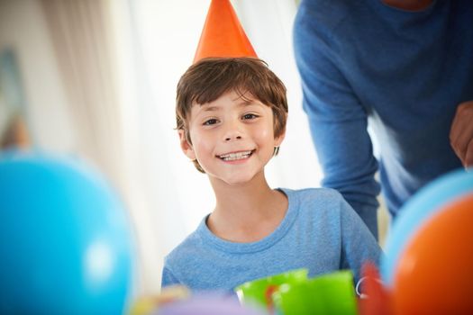 Happy birthday to me. Portrait of a happy little boy enjoying a birthday party at home.