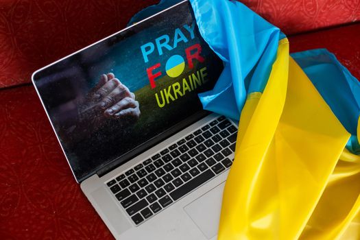 Ukraine flag. Pray for Ukraine. laptop. Flag of Ukraine. Stop War. No War.