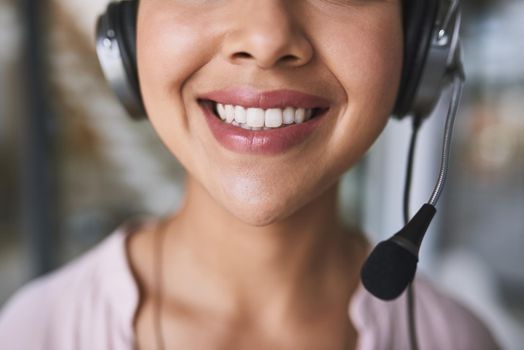 One has to keep a bright smile at all times in this line of work. Cropped shot of a cheerful unrecognizable businesswoman talking to customer using a headset.