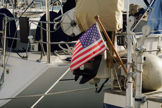 United States American national flag on the back of a moored boat.