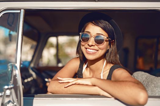 This is gonna be one memorable summer. Shot of a happy young woman going on a road trip.