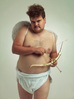 Hes bringing the love this Valentines. An obese man dressed as a cherub while isolated.