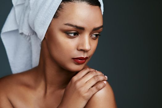 Get up and be whatever you want to be today. Cropped shot of a beautiful young woman posing with a towel on her head.