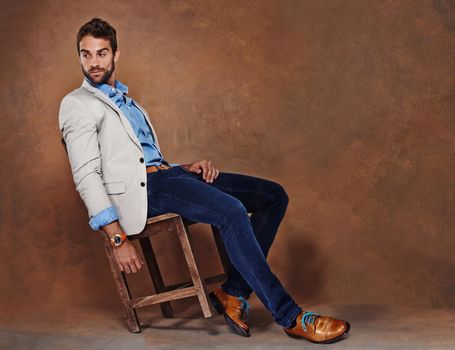 Laid-back style. Studio shot of a stylishly dressed young man.