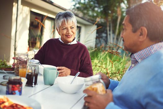 Retirement - Breakfasts just got better. Shot of a happy older couple enjoying a leisurely breakfast together outdoors.