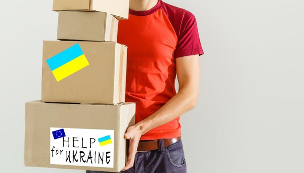 a man holds a box with humanitarian aid to ukraine