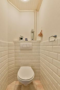 Bathroom interior with a hinged toilet