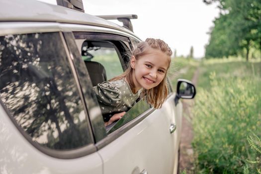 Preteen girl with car at the nature