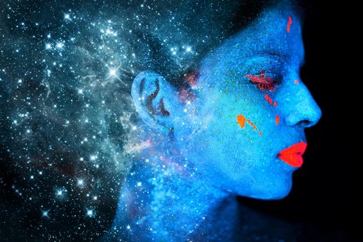 Celestial beauty. Shot of a young woman posing with neon paint on her face.