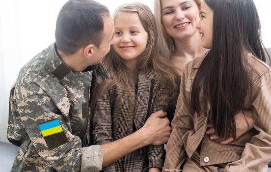 Happy Ukrainian soldier in military, cheerful daughter, Ukrainian veterans of Russian-Ukrainian, Independence Day