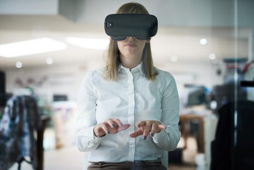 Business only moves forward when it embraces technology. Multiple exposure shot of a young businesswoman wearing a VR headset while working alone in her office.