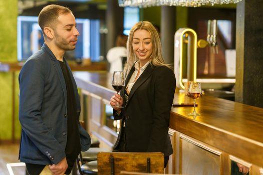 Happy diverse couple spending time in pub