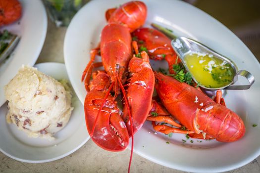 Lobster dinner with potato salad and butter