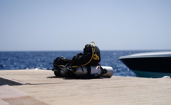 Diving equipment lying on wooden bridge in sea