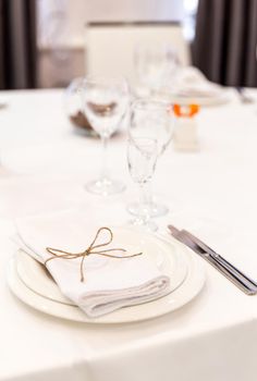 Plate, forks, napkin and knife in restaurant