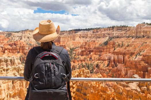 Woman wearing hat looking at the Bryce Canyon, Utah USA