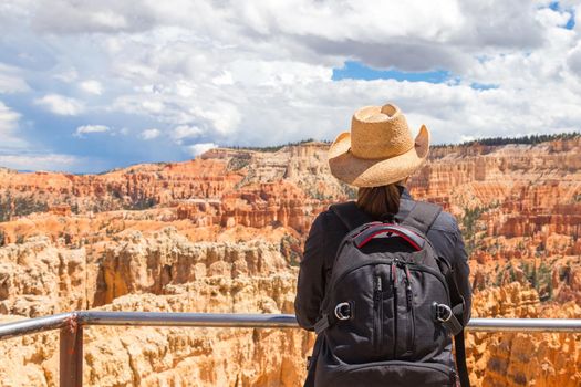 Woman wearing hat looking at the Bryce Canyon, Utah USA