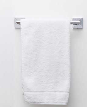 Modern bathroom towel dryer on white wall background
