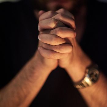 Praying for forgiveness. Closeup shot of a man with his hands clasped in prayer.