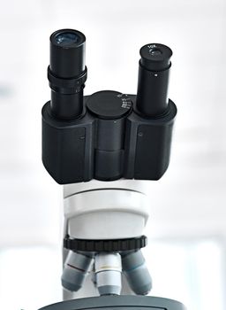 Are you up for doing some investigation. Still life shot of a microscope placed in a laboratory with its eyepiece facing upwards.