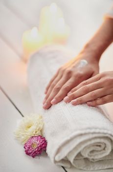 Her hands take softness to a new level. Cropped shot of a womans hands on a towel at a spa.