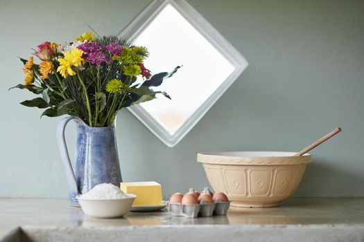 Happiness is homemade. Shot of a counter with baking ingredients arranged on it in a country kitchen.