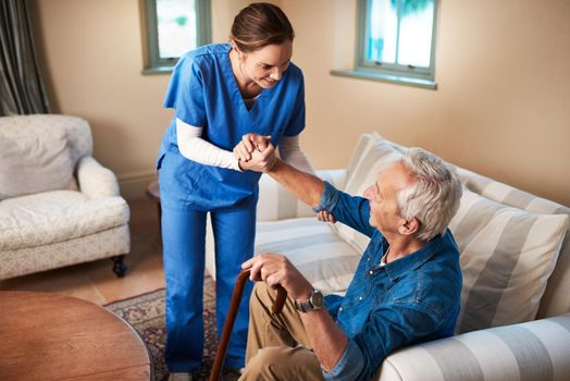 Her caring nature makes her the perfect caregiver. Shot of a caregiver assisting her senior patient at home.