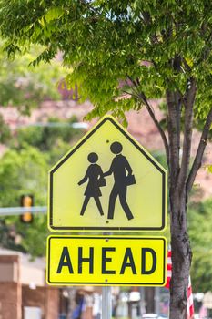 Crosswalk Sign Against green trees in small american town