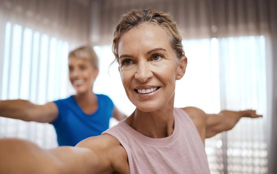 The person judging you is probably not your soulmate. Shot of two mature women exercising together at home.