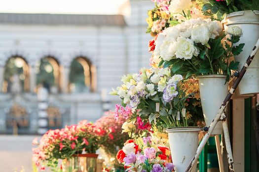 Outdoor flower market with roses, peonies and lilies. Fresh flowers street shop in historic downtown. Milan