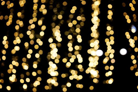 Defocused lights of christmas garlands, golden bokeh light