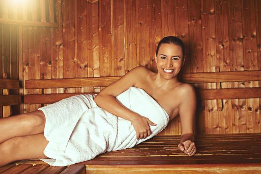Enjoying some rest and relaxation at the spa. Cropped portrait of a young woman relaxing in the sauna at a spa.