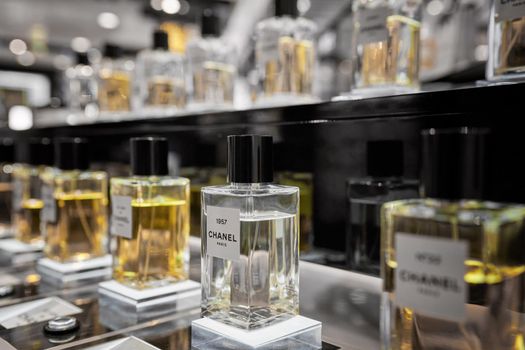 Female perfume Chanel No. 22 bottle closeup in store showcase. Perspective view of french Chanel perfume collection. Milan, Italy - December 15, 2020.