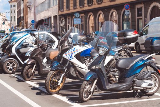 Motorcycles parked in a row in european city center. Motorcyclists community travel concept. Milan, Italy - September 24, 2020.