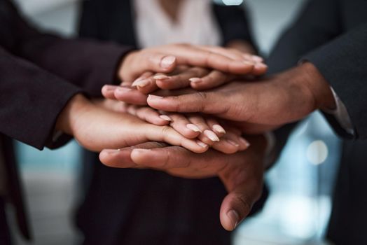 Trust is our foundation. Cropped shot of a group of unrecognizable businesspeople joining their hands together in a huddle.